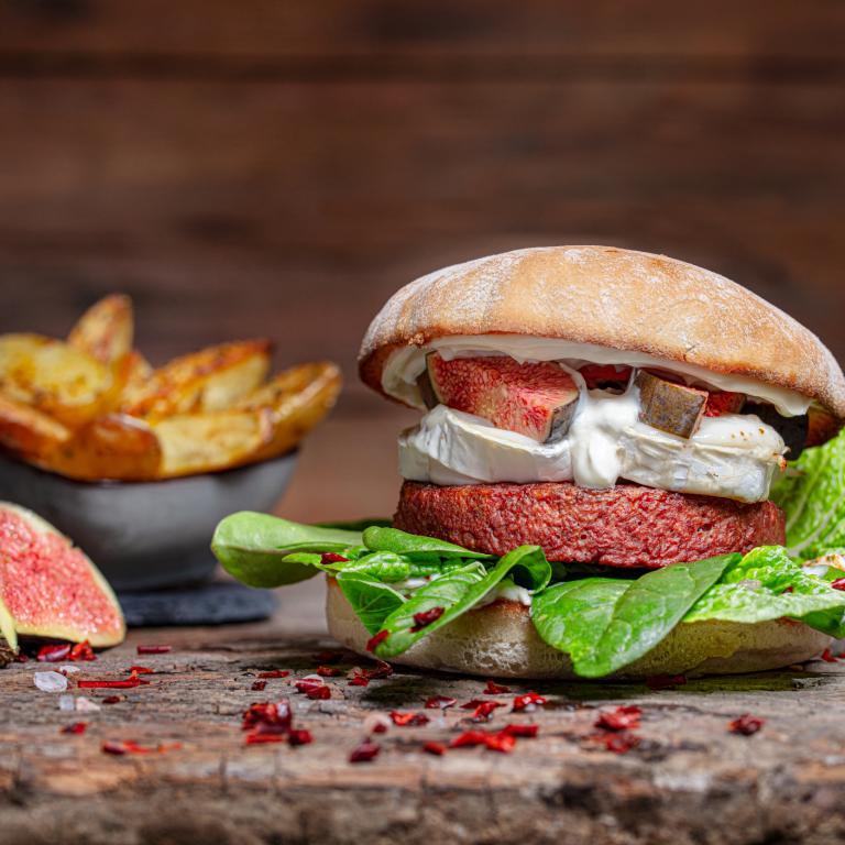 Vegetarischer Burger mit Ziegenkäse, Honig, Feige und Wildkräutersalat